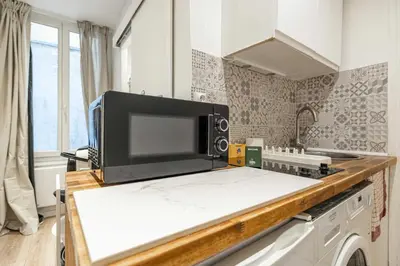 a microwave oven sitting on top of a kitchen counter at Cozy Apartment a-c 1BR-2P - Nice in Nice