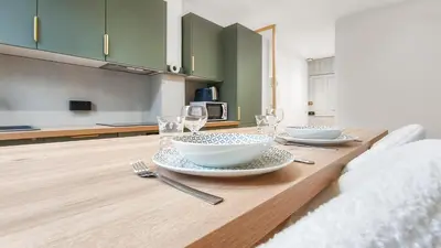 a table with two plates and wine glasses on it at T2design, élégant & calme à Nice in Nice