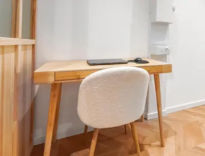 a wooden desk with a chair and a laptop on it at T2design, élégant & calme à Nice in Nice