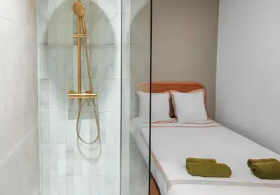 a bedroom with a glass shower with a bed at T2design, élégant & calme à Nice in Nice