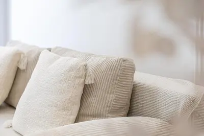a white couch with three pillows on it at Coup de cœur 3 couchages Quartier du Port in Nice