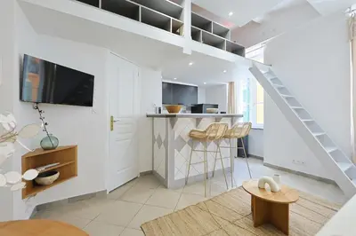 a white living room with a staircase and a living room at Coup de cœur 3 couchages Quartier du Port in Nice