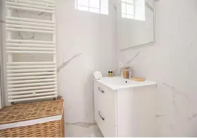 a white kitchen with a sink and a mirror at Magnifique Confortable & Rénové au Port de Nice in Nice
