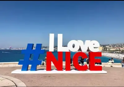 a sign that reads love nike in front of the ocean at Magnifique Confortable & Rénové au Port de Nice in Nice