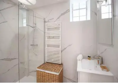 a white bathroom with a shower and a sink at Magnifique Confortable & Rénové au Port de Nice in Nice