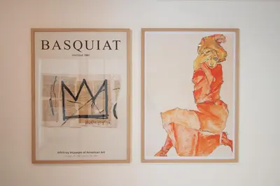 two framed pictures of a woman on a wall at Confort, modernité & calme au Port de Nice in Nice