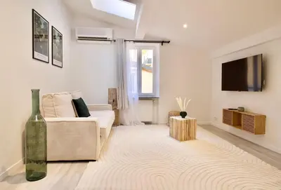 a living room with a couch and a tv at Magnifique appartement rénové au port de Nice in Nice