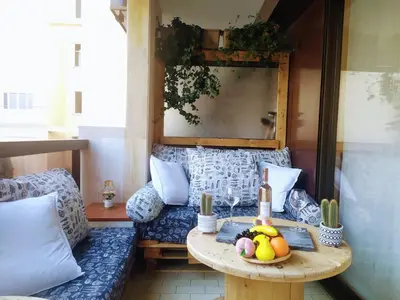 a table with fruits and vegetables on a balcony at WeHost BARETY - Blooming Balcony Retreat - Central 3-4prs in Nice