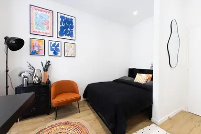 a bedroom with a bed and a desk and a chair at Studio Cosy et confortable hyper centre in Nice