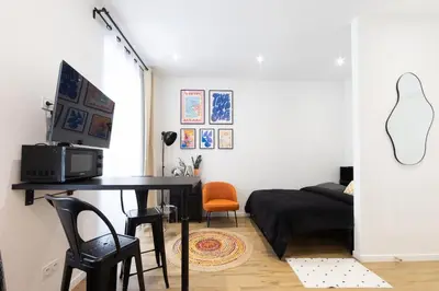a bedroom with a desk with a computer and a bed at Studio Cosy et confortable hyper centre in Nice