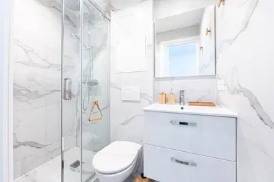 a white bathroom with a toilet and a shower at Studio Cosy et confortable hyper centre in Nice