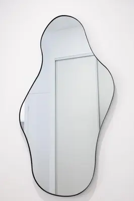 a glass vase with a mirror on a white background at Studio Cosy et confortable hyper centre in Nice