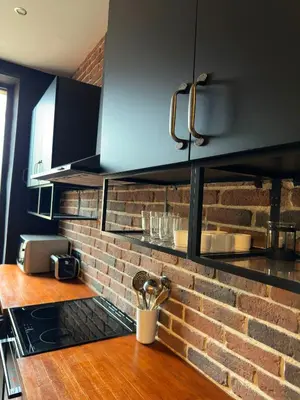 a kitchen with a brick wall and a counter top at Renovated 2-room apartment Sleeps 4 Tram and shops nearby in Nice