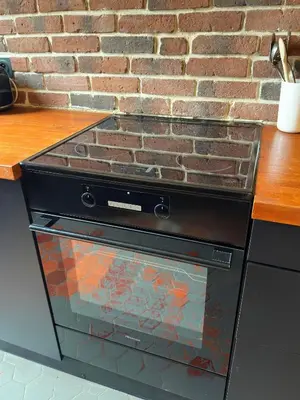 a stove top oven sitting next to a brick wall at Renovated 2-room apartment Sleeps 4 Tram and shops nearby in Nice