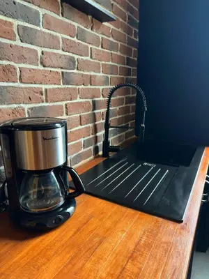 a coffee maker sitting on top of a wooden counter at Renovated 2-room apartment Sleeps 4 Tram and shops nearby in Nice