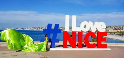 people walking on a street in front of a large building at WeHost Étoile de Nice 2lits 4pers Tout à pied in Nice