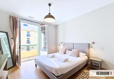 a bedroom with a bed and a large window at Nestor&Jeeves - GELATO - Bright - Balcony in Nice
