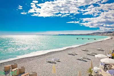an apartment building with palm trees in front of it at WeHost Promenade - garden retreat for 2 pers 1bed in Nice