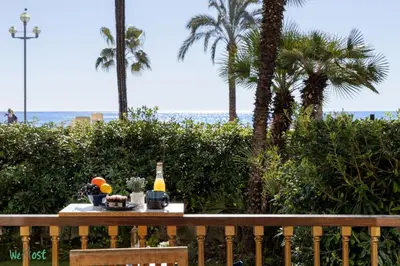 a living room with a blue couch and a table at WeHost Promenade - garden retreat for 2 pers 1bed in Nice