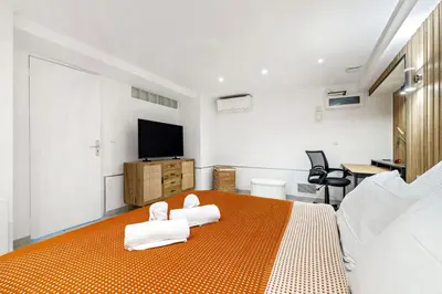 a bedroom with a bed with towels on it at Appartement Charme de la Promenade vue mer - Welkeys in Nice