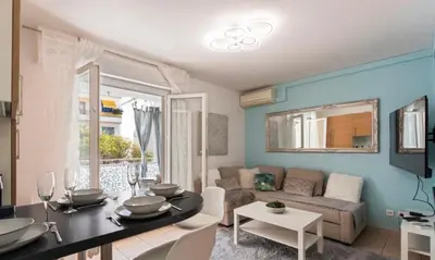 a living room with a table and a couch at Le MIAMI in Nice