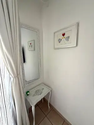 a dressing room with a mirror and a table at Le MIAMI in Nice