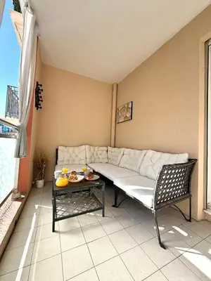a living room with a couch and a table at Le MIAMI in Nice