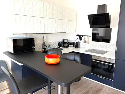 a kitchen with a table with an orange bowl on it at Hyper centre massena in Nice