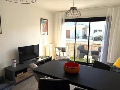 a living room with a tv and a table and chairs at Hyper centre massena in Nice