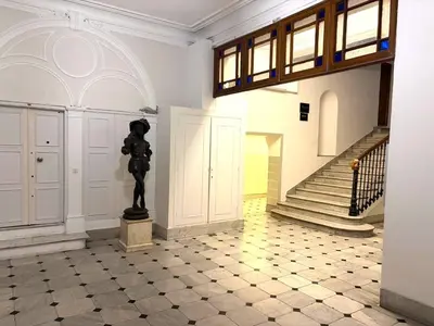 a statue in the middle of a room with a staircase at Hyper centre massena in Nice