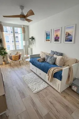 a bedroom with a bed and a ceiling fan at Charmant studio avec terrasse pour amoureux in Nice
