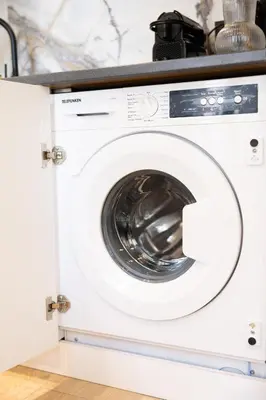 a white washing machine in a kitchen at Duplex moderne climatisé Carré d'or in Nice