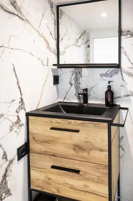 a bathroom with a sink and a mirror at Duplex moderne climatisé Carré d'or in Nice