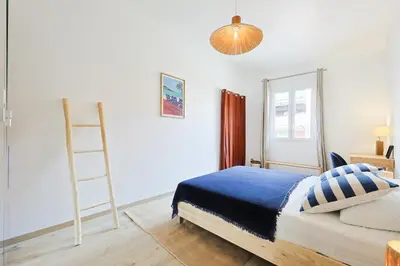 a bedroom with two mirrors on the wall next to a bed at Appartement charmant & cosy au cœur du Vieux Nice in Nice