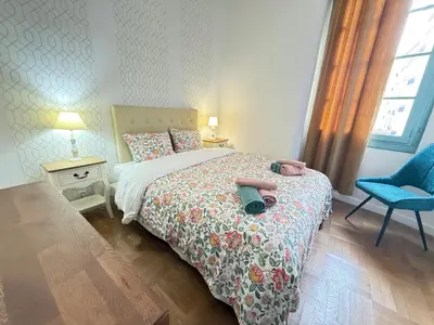 a bedroom with a bed with a pair of shoes on it at La Rotonde Art,elegance & romantisme au Coeur de Nice, à 2 pas du Negresco in Nice