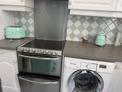 a kitchen with a stove and a washing machine at La Rotonde Art,elegance & romantisme au Coeur de Nice, à 2 pas du Negresco in Nice