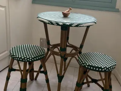 a stool with a table and two chairs at La Rotonde Art,elegance & romantisme au Coeur de Nice, à 2 pas du Negresco in Nice