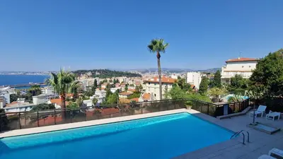 a swimming pool with a view of a city at Nice Mont Boron proche du Port in Nice