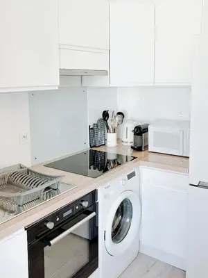 a white kitchen with a washing machine in it at Elegant Apartment with Balcony, Central Nice in Nice