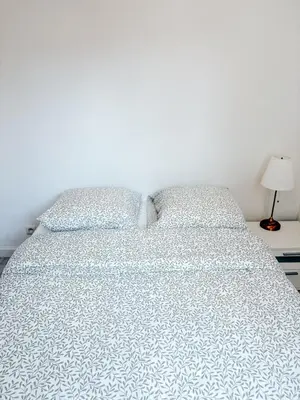 a white bed with two pillows on top of it at Elegant Apartment with Balcony, Central Nice in Nice