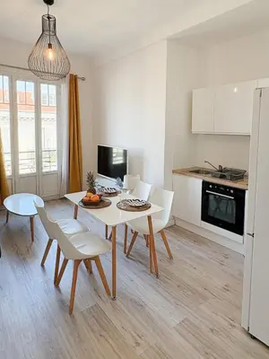 a kitchen and dining room with a table and chairs at Elegant Apartment with Balcony, Central Nice in Nice