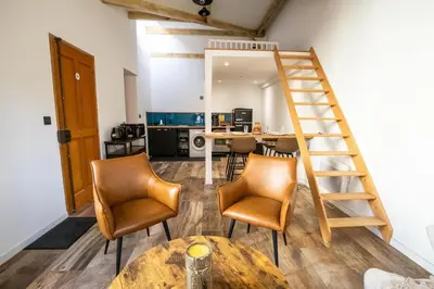 a room with a table and chairs and a ladder at Dolce Vita Clemenceau - Nice City Center 4 People in Nice