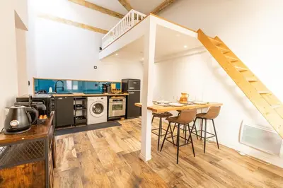 a kitchen and living room with a table and a staircase at Dolce Vita Clemenceau - Nice City Center 4 People in Nice