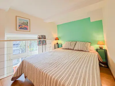 a bedroom with a bed and a green wall at Place Grimaldi - Wifi, AC, 3pers in Nice