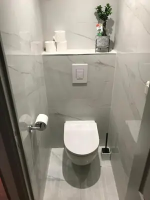 a bathroom with a white toilet in a stall at Appartement 3P Nice port Sea view in Nice