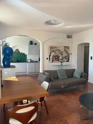 a living room with a couch and a table at Appartement 3P Nice port Sea view in Nice