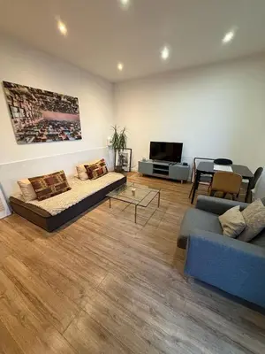 a living room with a couch and a tv at Appartement 3P Nice port Sea view in Nice