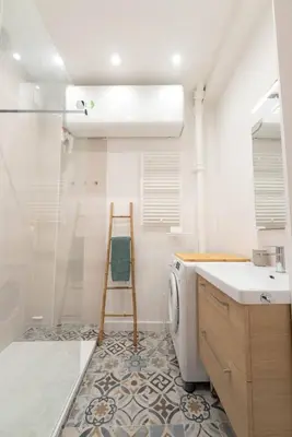 a bathroom with a sink and a washing machine at Bright apartment Nice harbour in Nice