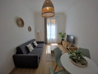 a living room with a couch and a table at Bright apartment Nice harbour in Nice