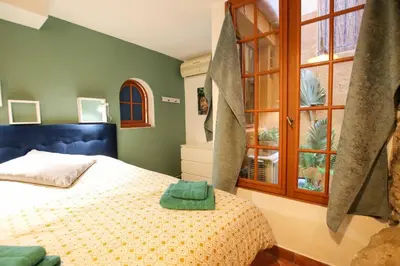 a bedroom with a bed and a window at ROCHE-Rock in the heart of the Old Town in Villefranche-sur-Mer